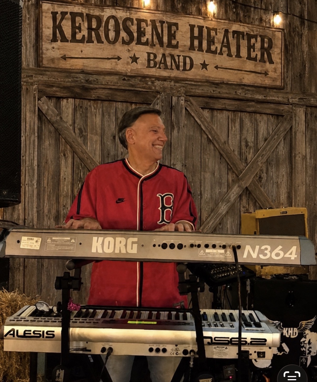 Keyboard player performing in a red jersey